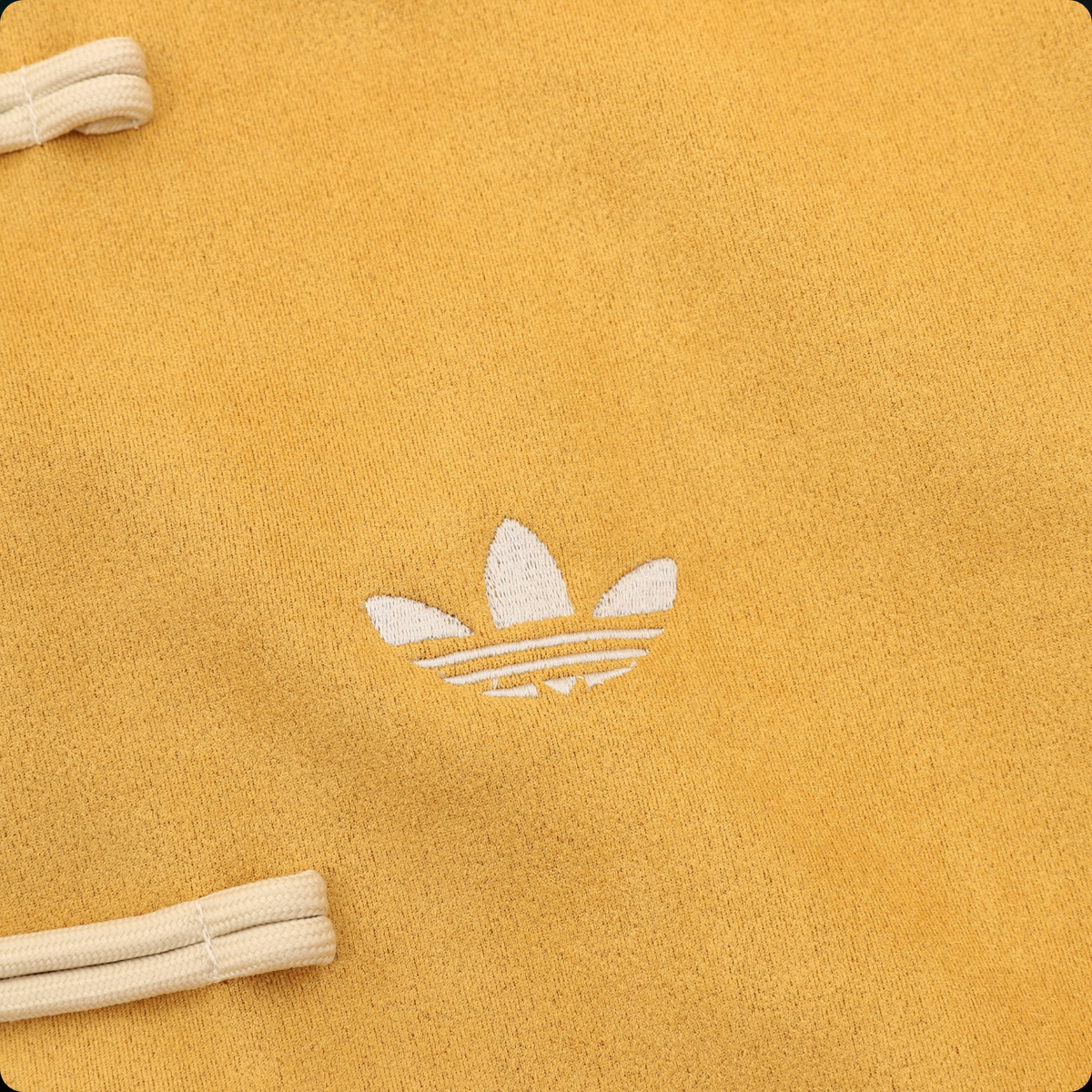 Chamarra adidas Tang Año Nuevo Chino amarilla, detalle del logo